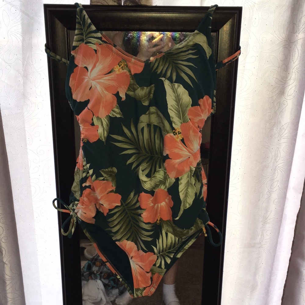 One piece bathing suit, green with coral colored flower design.